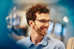 man with glasses smiling