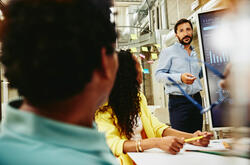Three colleagues having a meeting in a meeting room.