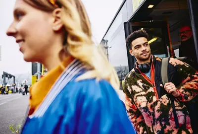 People getting out of a bus.
