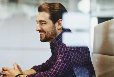 Man with beard in an office. 