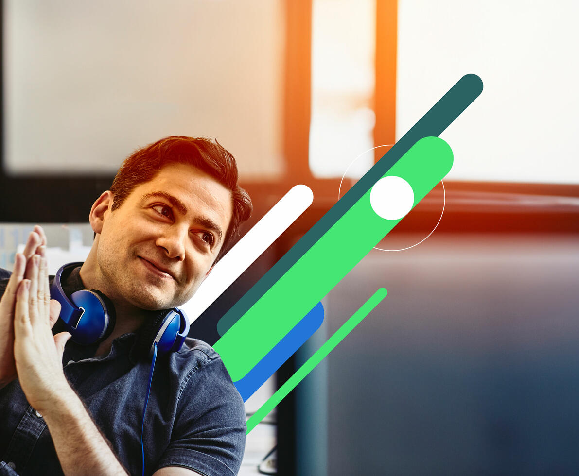 man smiling at his desk